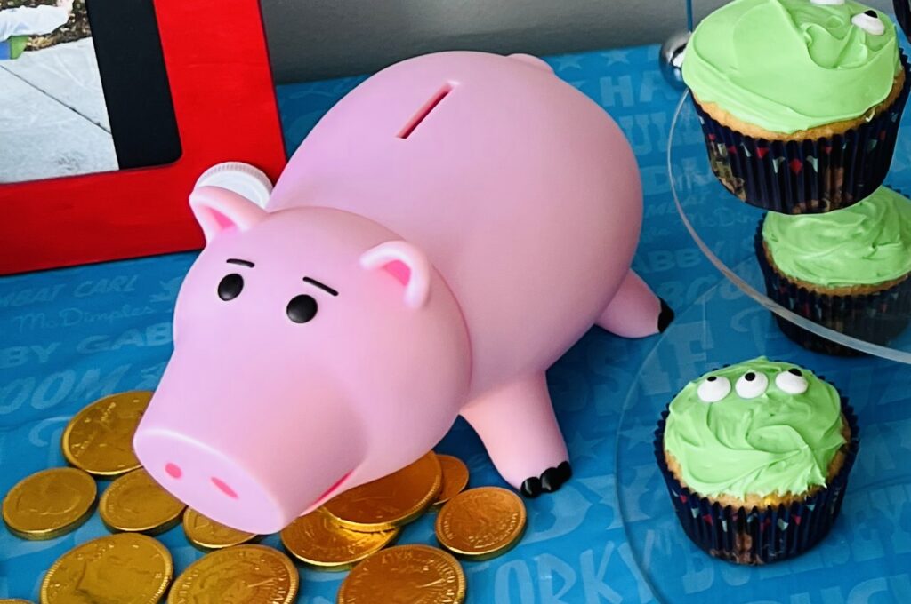 Toy Story Ham piggy bank with scattered chocolate coins as table decoration