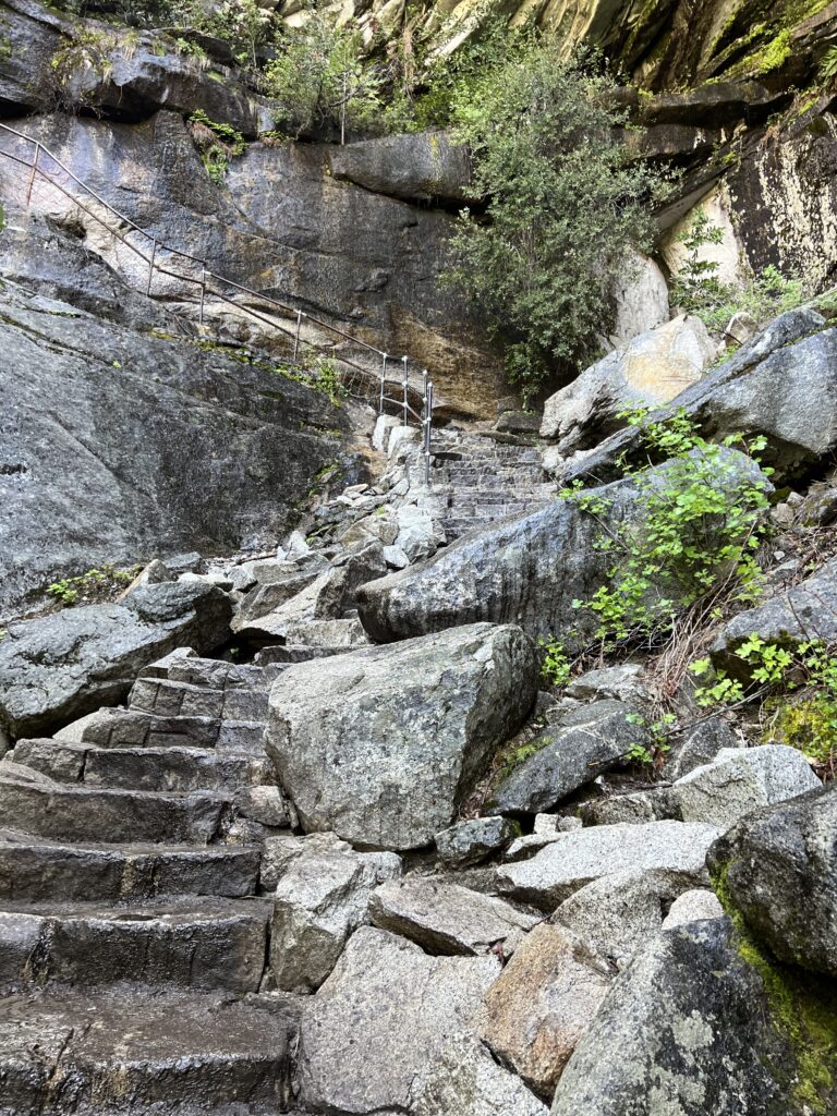 Winding granite staircase lined with boulders